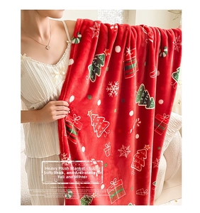 Close-up of thick red flannel blanket featuring festive Christmas trees and snowflakes