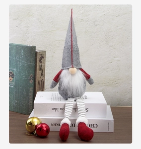 Detailed view of Christmas gnome doll with adjustable striped long legs on a white stand