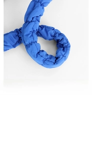 Detail of blue padded cloud bag strap with soft pleated texture and quilted nylon fabric