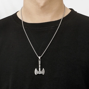 Detail of Viking double-axe pendant on a silver box chain worn on a black sweater
