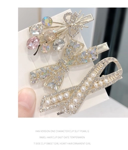 Detailed view of three silver hair clips with colorful rhinestones and faux pearls