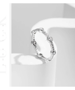 Detail shot of s925 silver ring with sparkling cubic zirconia on a white geometric base