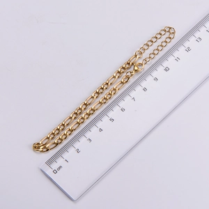 Detail view of 4.5mm golden Figaro chain with a ruler showing size and link texture