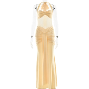 Detail of light yellow halter dress featuring soft ruched fabric and knot drapery details