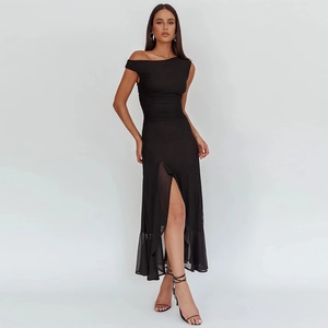 Detail of elegant black off-shoulder dress with high side slit and ruffled hemline