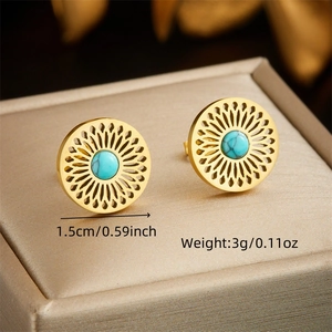 Vintage stainless steel sunburst earrings with turquoise stone insets on textured surface