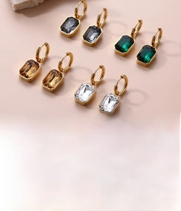Detail showing titanium steel earrings with zircon stones and golden vacuum plating