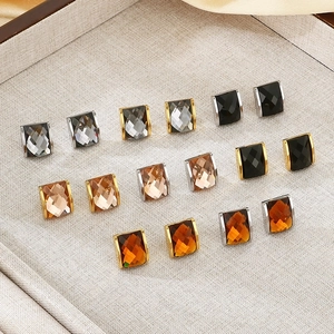 Macro shot of rectangular multi-color glass earrings set in 18K gold-plated frames
