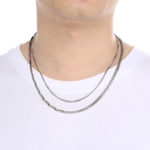 Silver double-layer layered necklace featuring cuban link and bar design on a model
