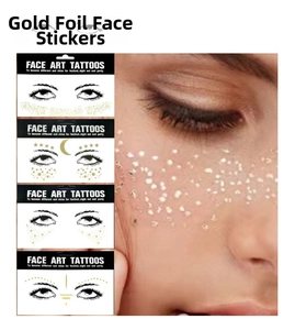 Detail of four metallic gold freckle tattoo stickers featuring star and moon designs