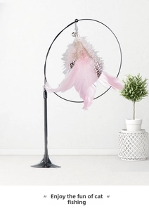 Detail of stable suction base and wire wand with pink feather cat toy and bell
