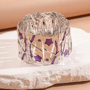 Detail of silver square-link bracelet with purple star enamel and textured metal surface
