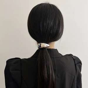 Minimalist silver metal arched hair ring for ponytail on a back view of a female model