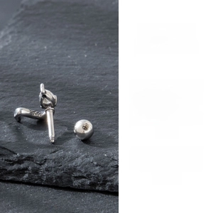 Detailed view of silver curved stud earring with sparkling zircon and ball screw back