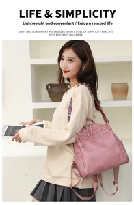 Pink faux leather backpack with geometric strap shown worn by a model in a studio setting