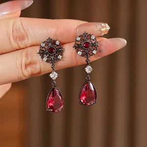 Vintage silver needle earrings with ruby red teardrop crystals and filigree flower motifs