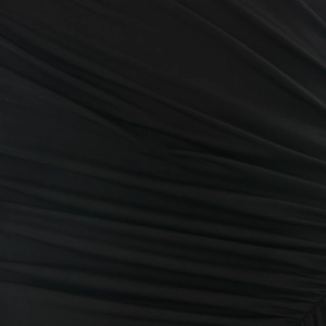 Close-up of black sleeveless dress fabric featuring soft pleated folds and elastic texture