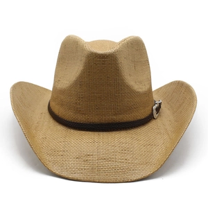 Close-up of straw western cowboy hat with brown leather band and silver buckle detail