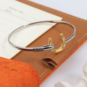 Two-tone horseshoe cuff bracelet with 18K gold plating and cubic zirconia on leather