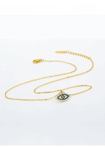 Close-up of gold titanium evil eye pendant necklace with blue enamel and pavé stones