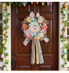 Easter wreath with cute rabbit head, pink roses, and colorful ribbons on a dark wood door
