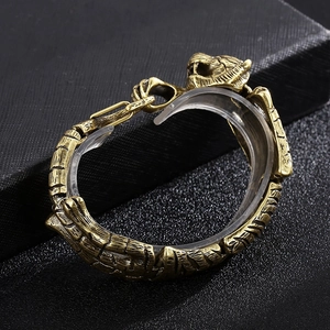 Close-up of vintage gold tiger head bracelet made of antique steel on black texture
