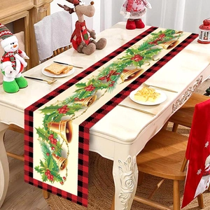Close-up of Christmas table runner with red-black plaid edge and festive berry patterns