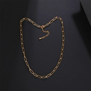 Close-up of golden rectangular link chain necklace with lobster clasp on black background