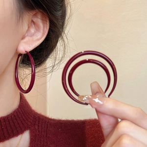 Minimalist deep red enamel hoop earrings for women with sleek silver needles design