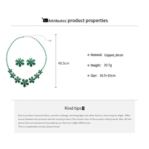 Detail view of flower necklace set with green zircon stones and copper base on white background
