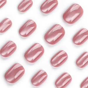 Glossy dusty rose cat-eye press-on nails with shimmering magnetic effect on white surface