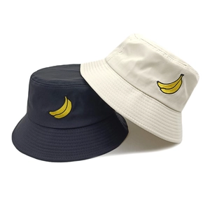 Unisex cotton bucket hat featuring banana embroidery in black and beige color options
