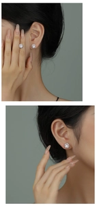 Detailed view of silver flower stud earrings with white zircon on elegant model