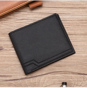 Close-up of black bifold leather wallet with geometric stitching on a wooden surface