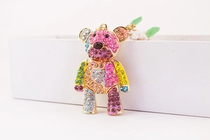 Detailed macro view of gold-plated bear keychain with colorful sparkling rhinestones