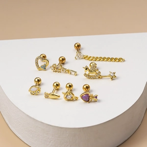 Golden surgical steel cartilage stud earrings with heart, carrot, and unicorn zircon charms