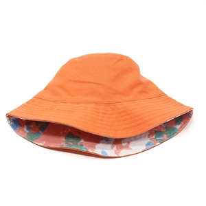 Detail of orange reversible bucket hat showing smooth canvas and vibrant floral lining