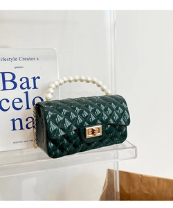 Detail of dark green quilted jelly bag with pearl handle and golden twist lock