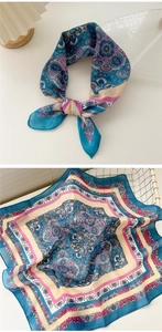 Detail of bohemian paisley cotton linen scarf with soft light and elegant blue patterns