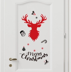 Close-up of Merry Christmas reindeer decal with red elk and snowflakes on a white door