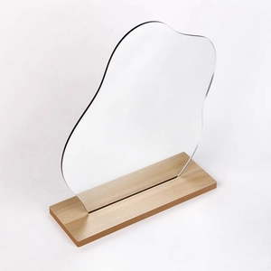 Irregular wavy acrylic vanity mirror with a natural wood base for desk decoration