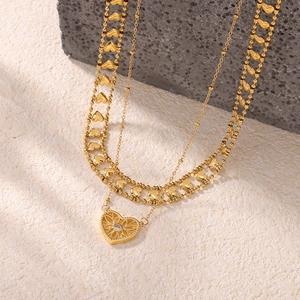 Double-layered gold heart pendant necklace with hollow design and zircon stone