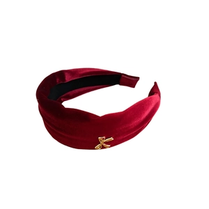 Elegant deep red velvet headband with a golden bow metal charm for a vintage aesthetic