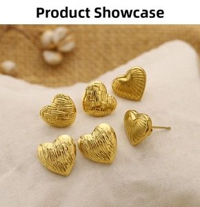 Macro detail of 18K gold plated heart stud earrings with diverse vintage textures