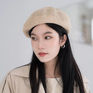 Close-up of beige knitted beret showing breathable linen texture and woven details