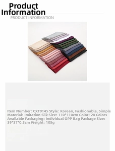 Macro detail of large matte satin silk square scarves layered in multiple solid colors