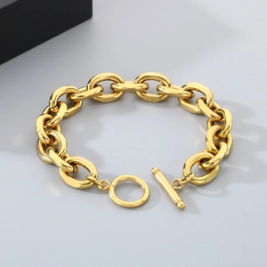 Detailed close-up of warm gold Cuban chain link bracelet with classic OT toggle clasp closure