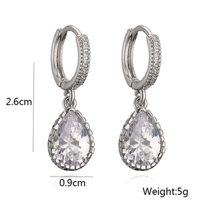 Detail view of silver teardrop earrings with dimensions 2.6cm and weights 5g in white background