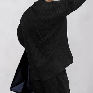 Detailed back view showing black knitted long sleeve shirt texture and fabric pattern