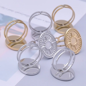 Close-up of adjustable stainless steel rings featuring geometric sunburst relief designs